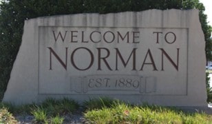 Welcome sign at the city limit that says Welcome to Norman.